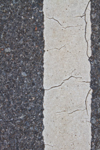 asphalt road with marking lines and tire tracks