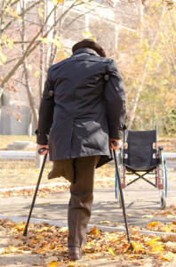 Handicapped one-legged man walking on crutches